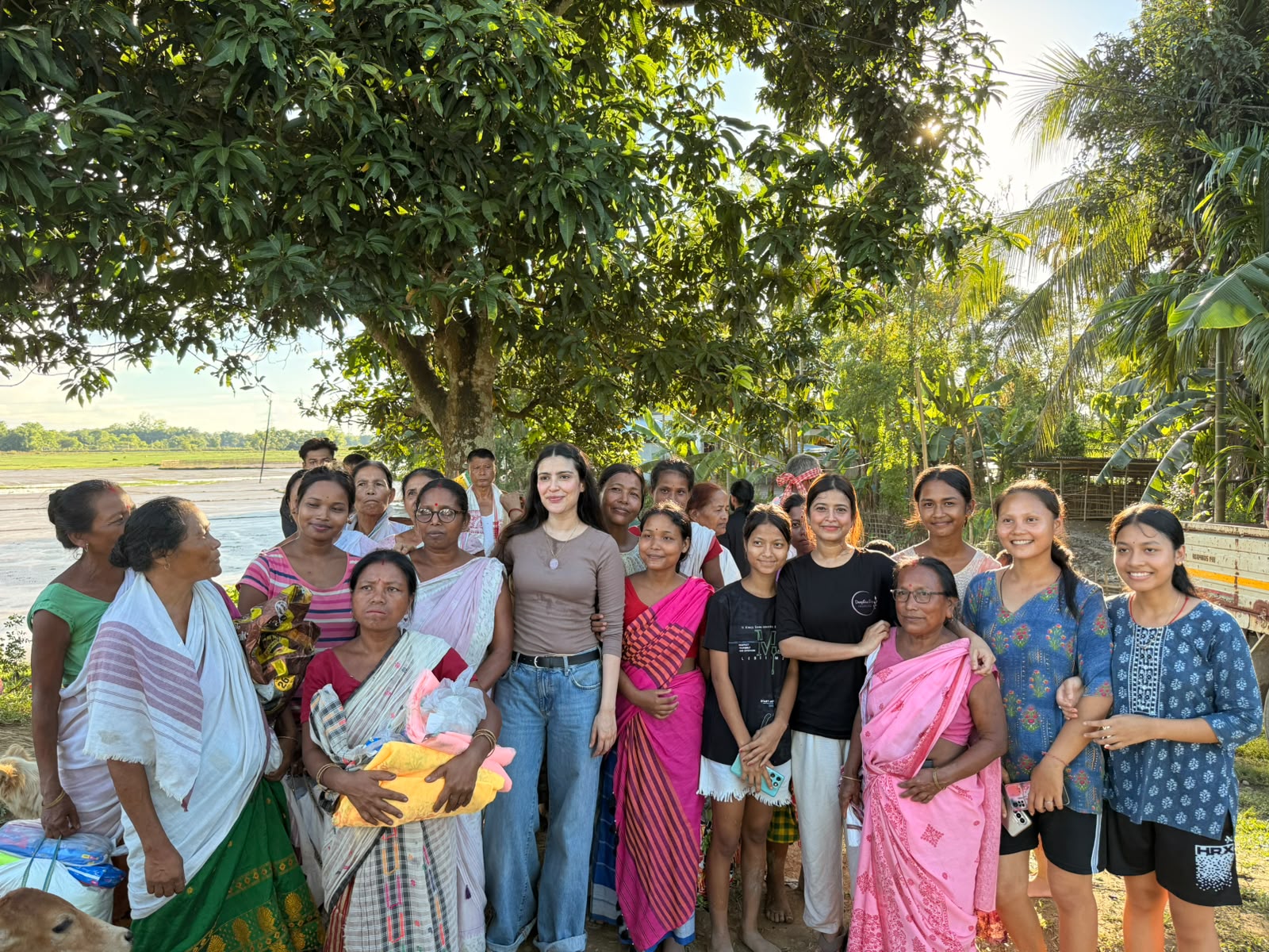 Foundation team members and village residents standing together after a relief handover