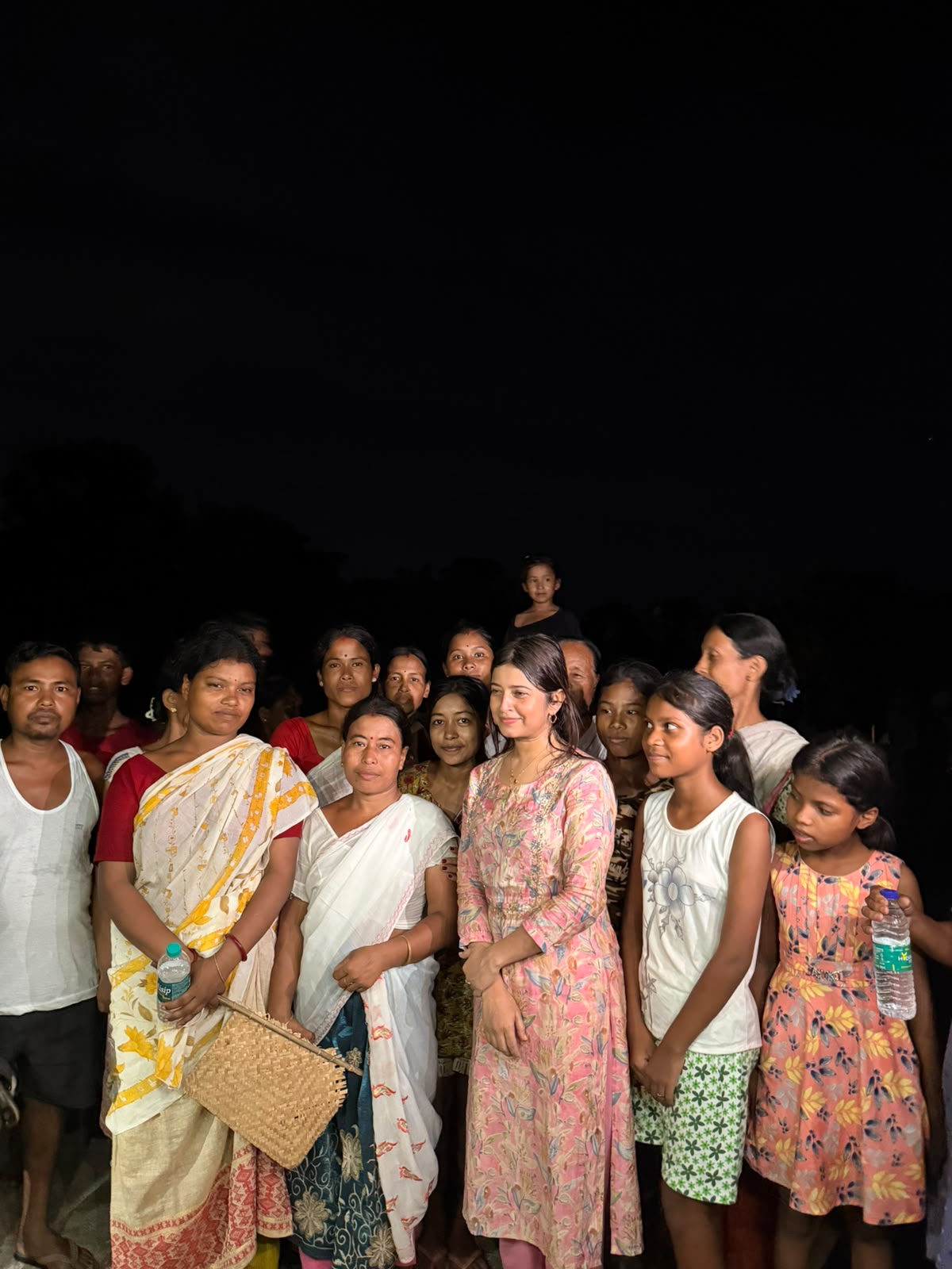 Community members and volunteers gathered after an outreach activity